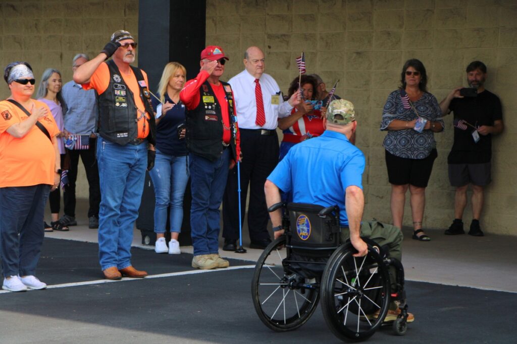 The Patriot Guard Riders of Florida salute Carlos Rivera as he enters Canvas Church. Photo by Lillian Hamman