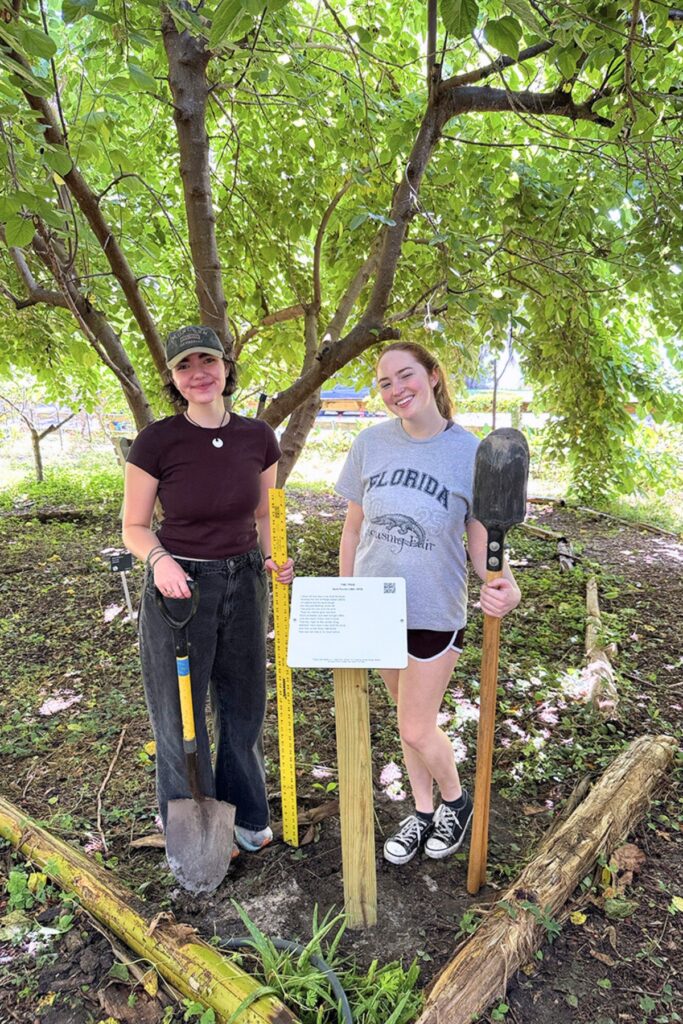UF poetry students with a Poetry in the Gardens poem. Courtesy of UF