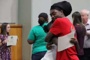 A family member embraces their Citizen of the Year.