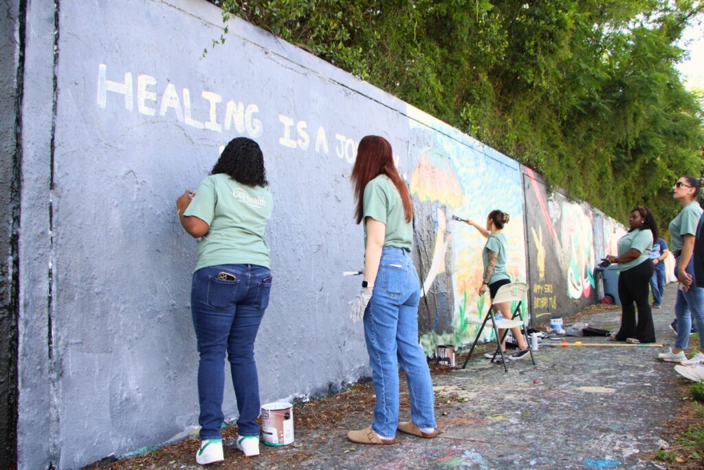 A team from UF Health Psychiatric Hospital creates mental health awareness mural. Photo by Lillian Hamman
