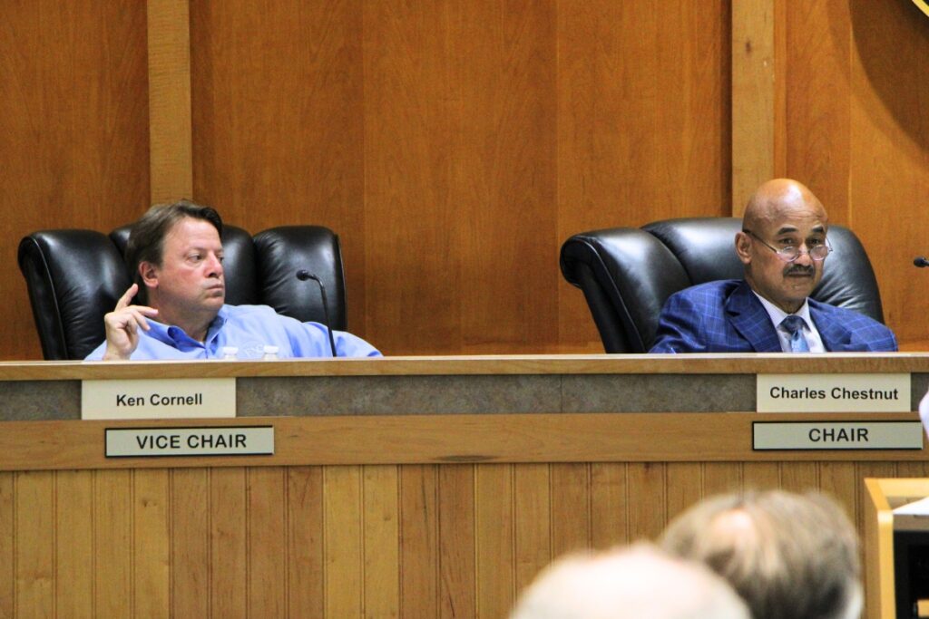 Alachua Commissioners Ken Cornell (left) and Charles Chestnut attend a joint meeting with the city of Alachua. Photo by Lillian Hamman