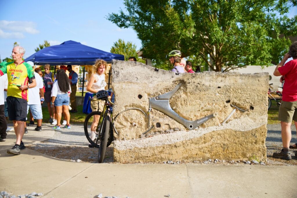 Attendees gather around the Share the Road Memorial prior to starting their Ride of Silence in Gainesville's Depot Park on Wednesday. Photo by Tim Rodriquez