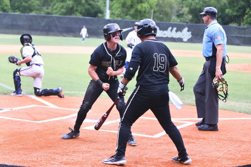 Buchholz's Hudson Sapp celebrates with Kai So (19) after tying the game 1-1 in the third inning against Pace in game two of the 6A Region 1 Final. Photo by C.J. Gish