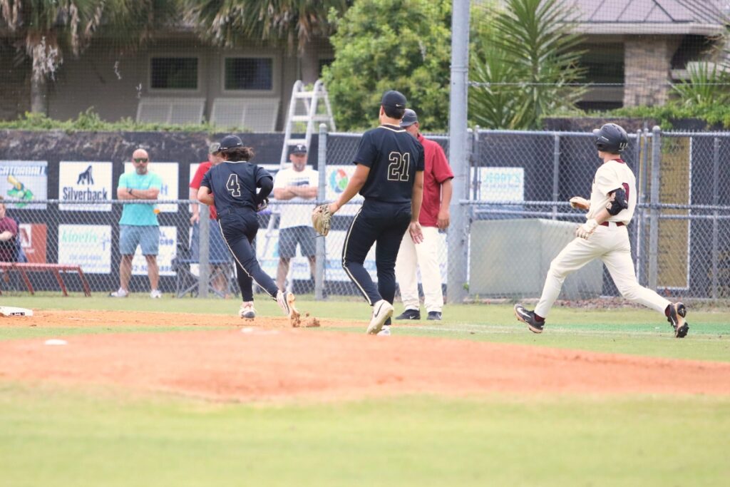 Buchholz's Zac Brown (4) races to get back to first base for a first-inning out against Tate (Contonment) in game two of the 6A Region 1 Semifinals. Photo by C.J. Gish