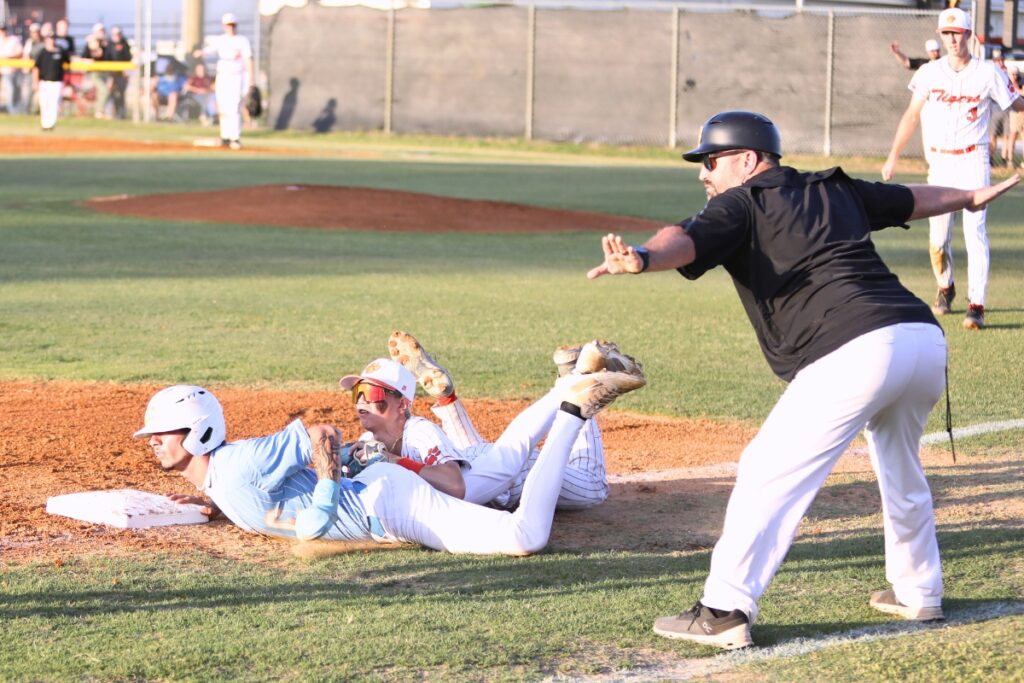 Chiefland's Devon Minichello beats the throw to Trenton third baseman Logan Marlo in the second inning of game two in the Rural Region 4 Semifinals. Photo by C.J. Gish