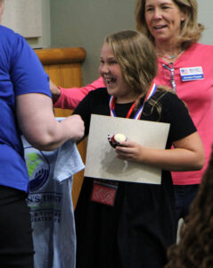 Finley Vereb of Archer Elementary School receives Citizen of the Year prizes.