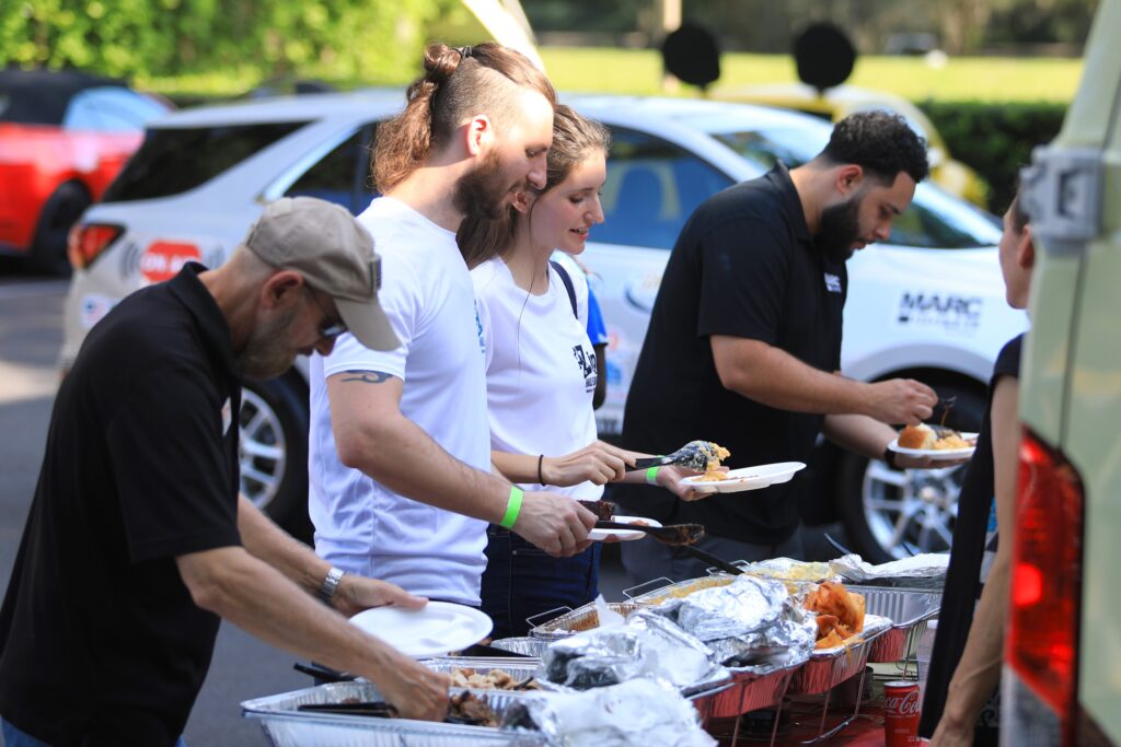 Guests fill their plates with Adam's Rib Company and Nothing Bundt Cakes. Photo by Seth Johnson