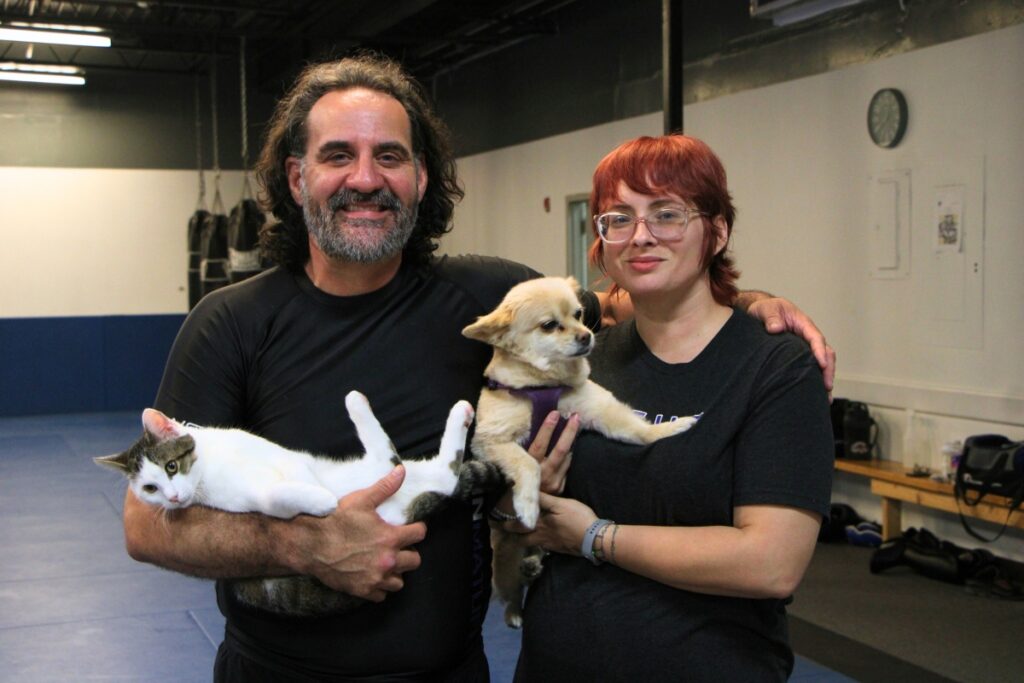 Jason (left) and Kim-Anne Dodd with cat Dojo and dog Coconut. Photo by Lillian Hamman