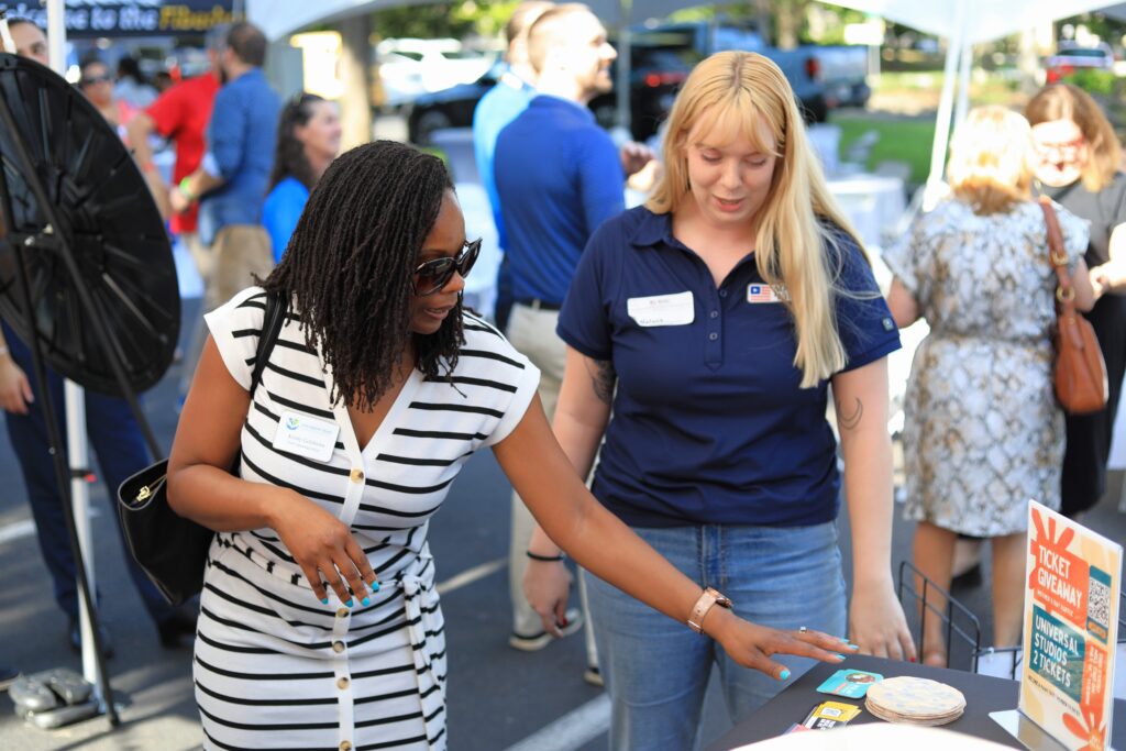 Kristi Goldwire with the Children's Trust of Alachua County picks her prize after spinning the giveaway wheel. Photo by Seth Johnson