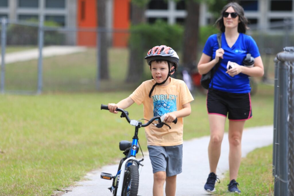 Leaving school, a student looks ahead to where a High Springs Fire Department engine and other emergency services providers wait with candy, helmets and other goodies. 