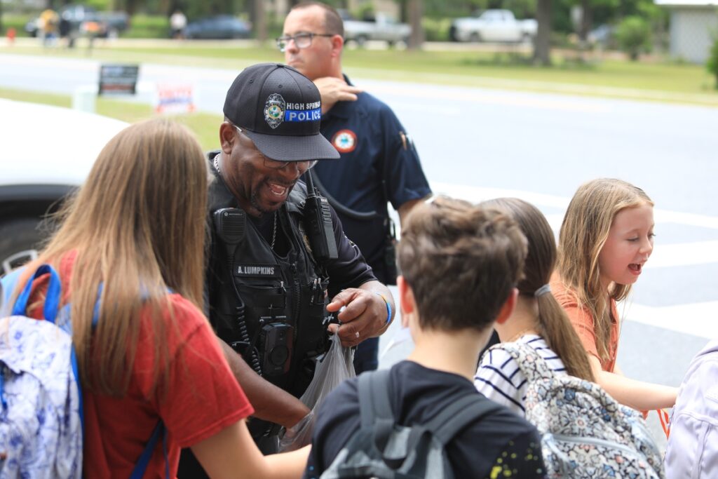 School Resource Officer Adrian Lumpkins hands out candy to High Springs Community School students. 