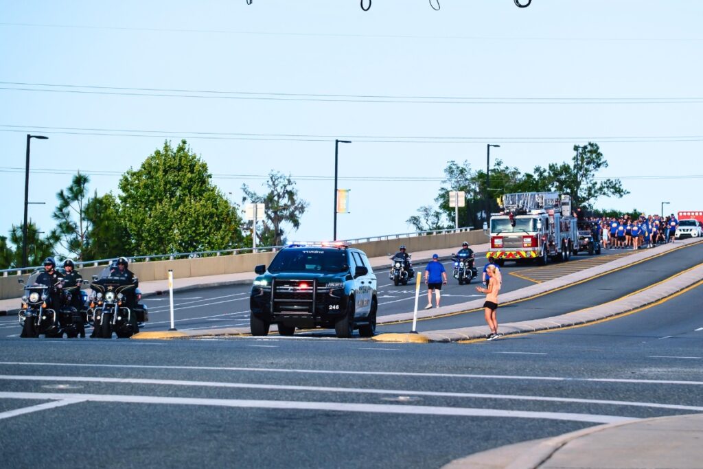 Participants cross the bridge to Celebration Point during the Law Enforcement Special Olympics Torch Run in Gainesville. Photo by Chris Watkins