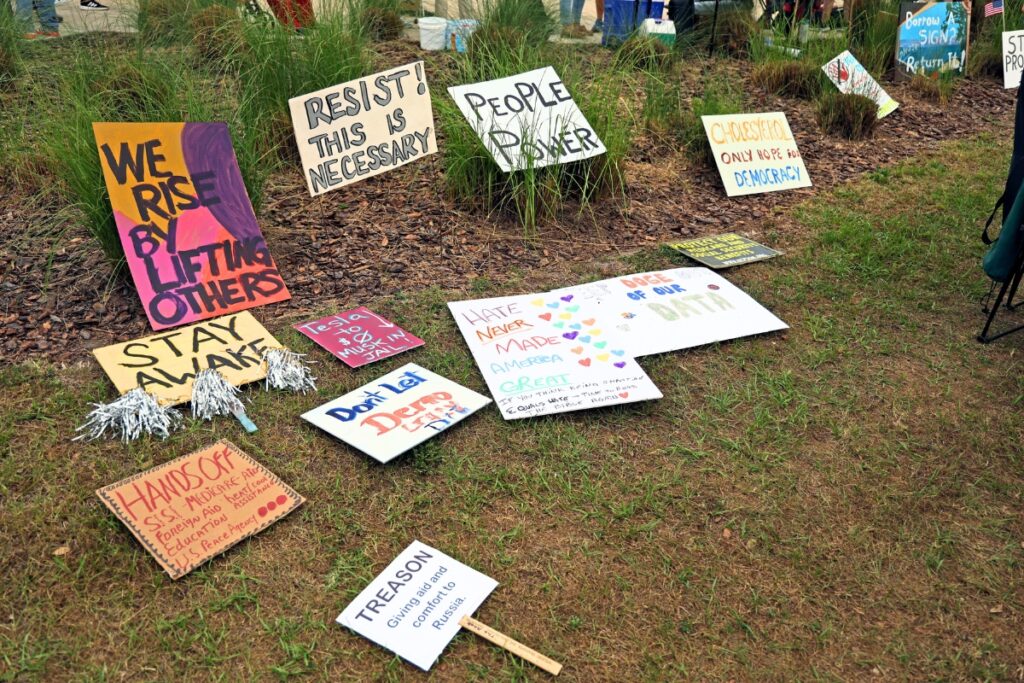 Signs at Thursday's International Workers' Day anti-Trump protest. Photo by Lee Ann Anderson