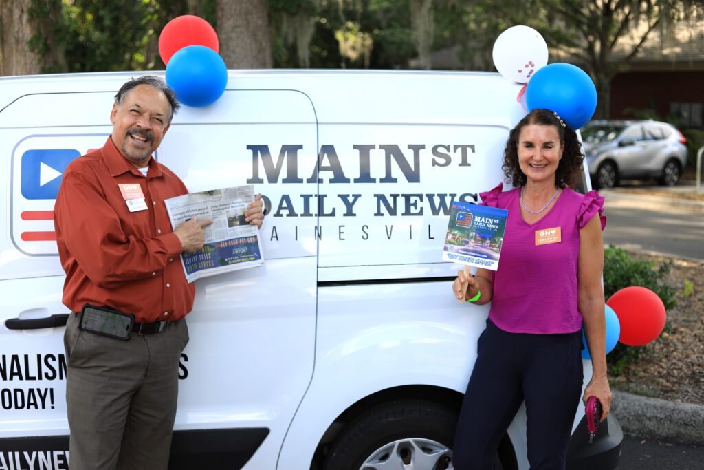Steve Jeppson with Florida Credit Union and Laura Bialeck with LifeSouth Community Blood Centers show Mainstreet love at the company's fifth anniversary. Photo by Seth Johnson