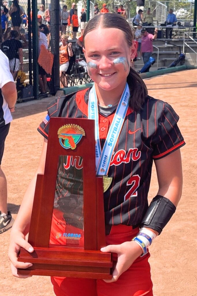 Trenton's Addison Allaire holds the state championship trophy. Photo by Mike Ridaught