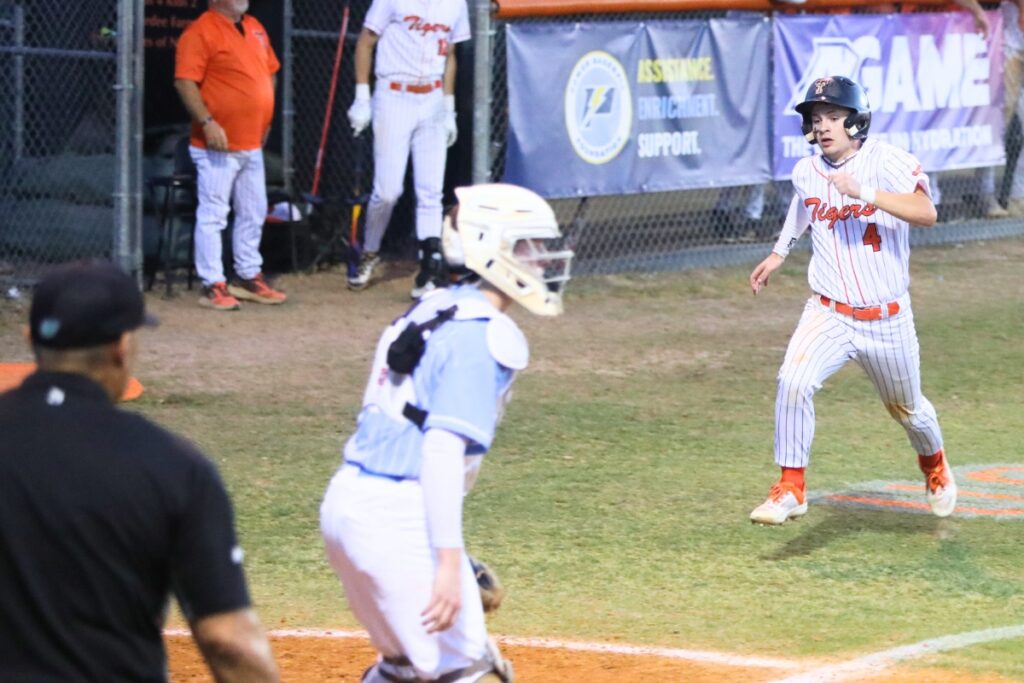 Trenton's Isaac Johnson (4) runs home to put the Tigers up 7-3 in the fifth inning against Chiefland in game two of the Rural Region 4 Semifinals. Photo by C.J. Gish