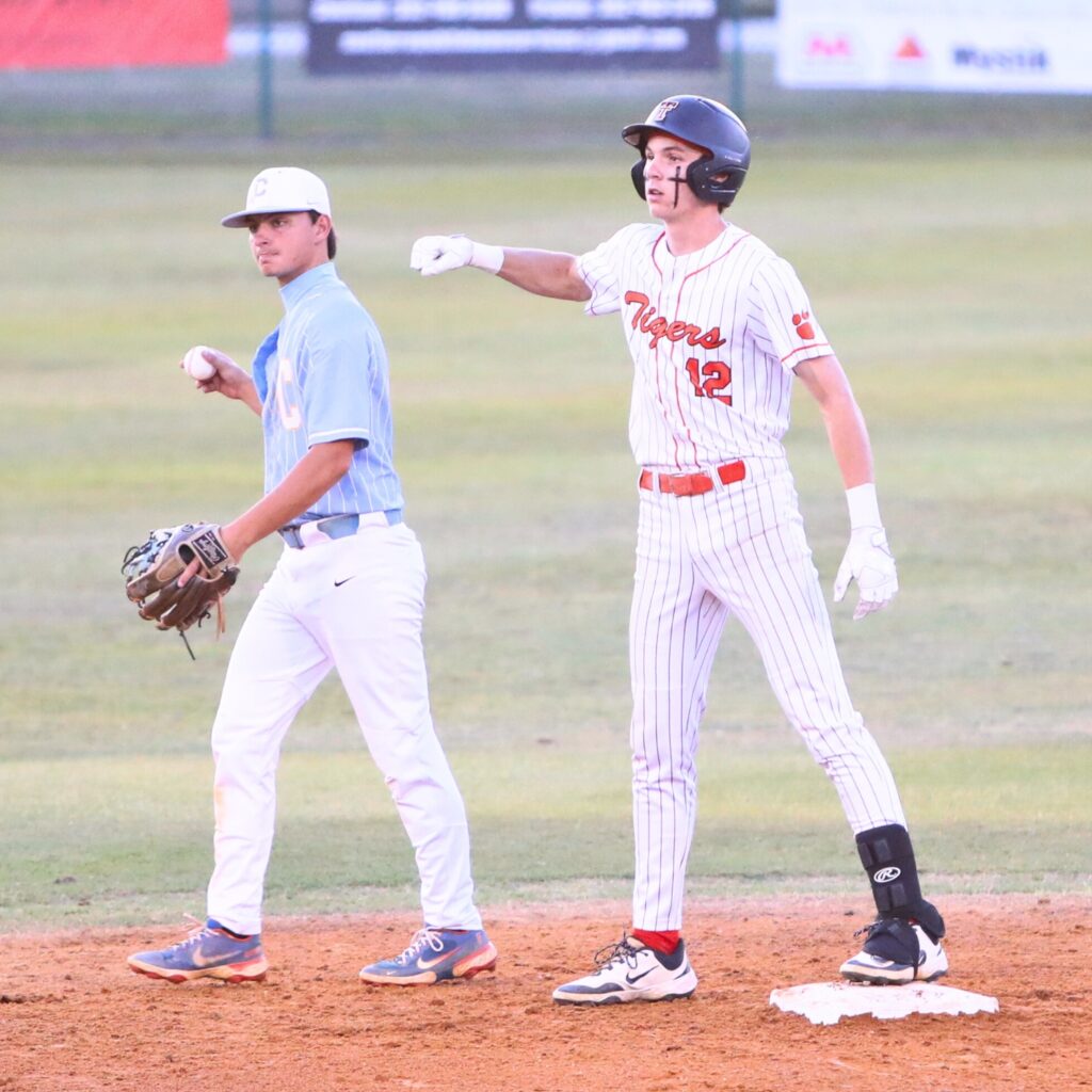 Trenton's Noah Owens (12) beats the throw to Chiefland's Taylor Brown for a fourth-inning double in game two of the Rural Region 4 Semifinals. Photo by C.J. Gish
