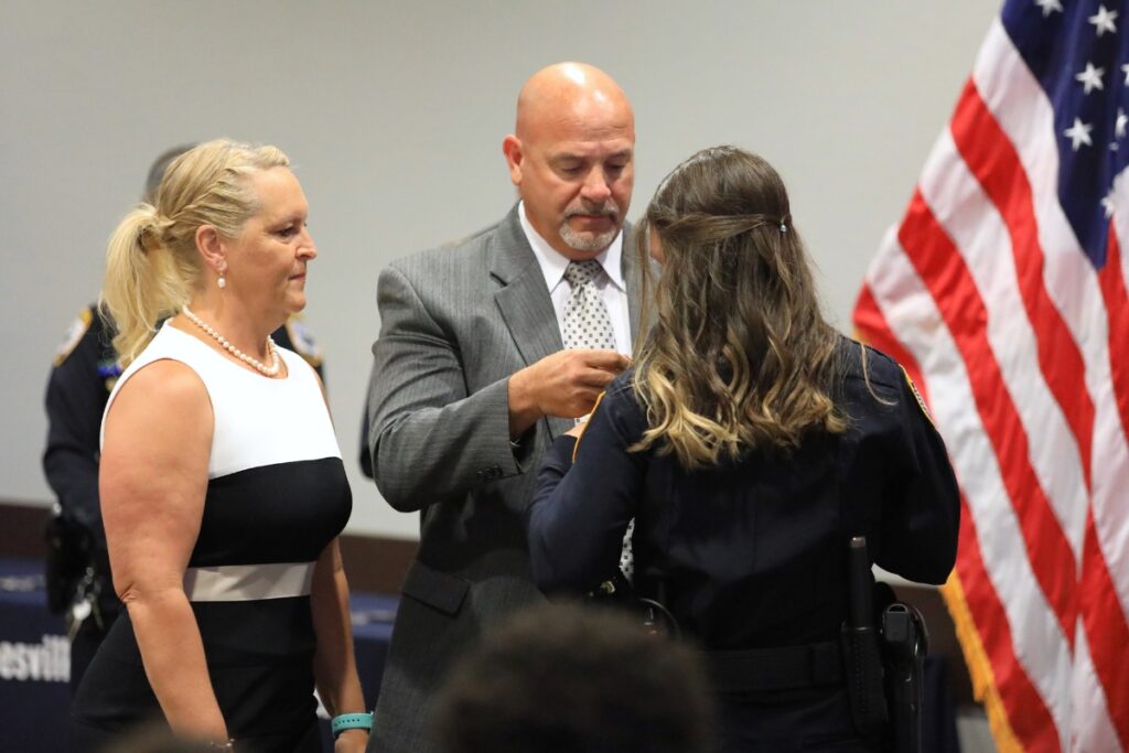 Officer Elizabeth Davey has her parents pin her GPD badge. 