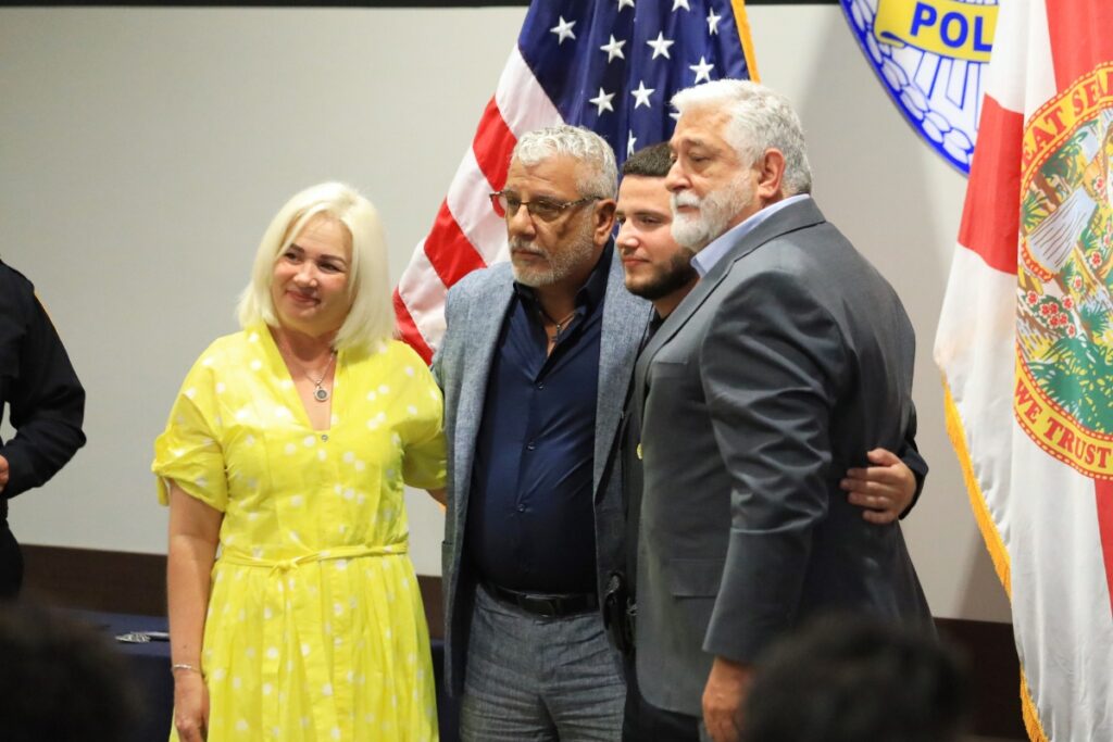 Officer Jordan Gonzalez and his family gather after getting his badge pinned. 
