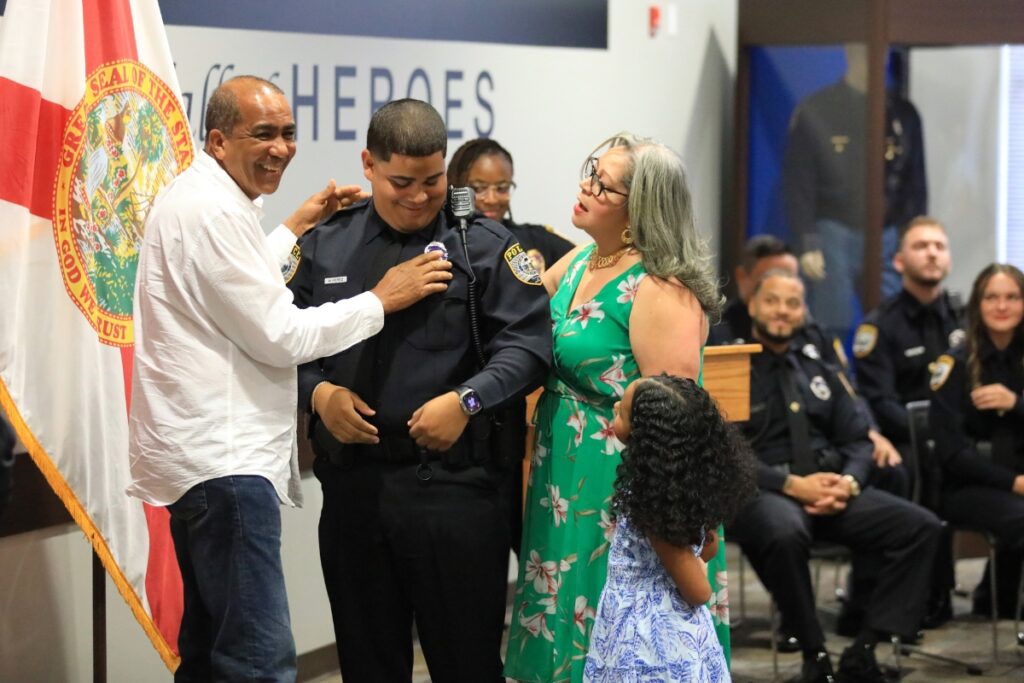 Officer Miguel Perez has his father pin his GPD badge along with his mother and daughter. 
