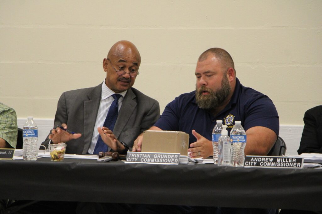 High Springs Mayor Tristan Grunder, right, speaks at a joint meeting with the Board of County Commissioners, with Chair Chuck Chestnut, right. 