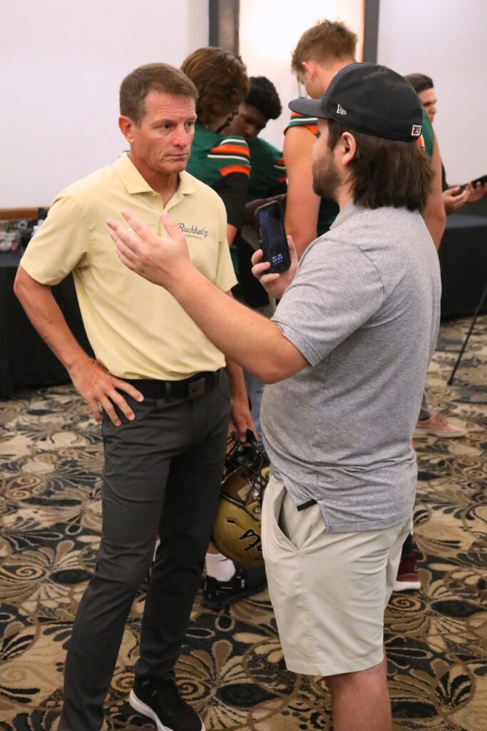 Cam Parker (right) interviews Buchholz coach Mark Whittemore at the North Central Florida High School Football Media Day on Thursday. Photo by C.J. Gish