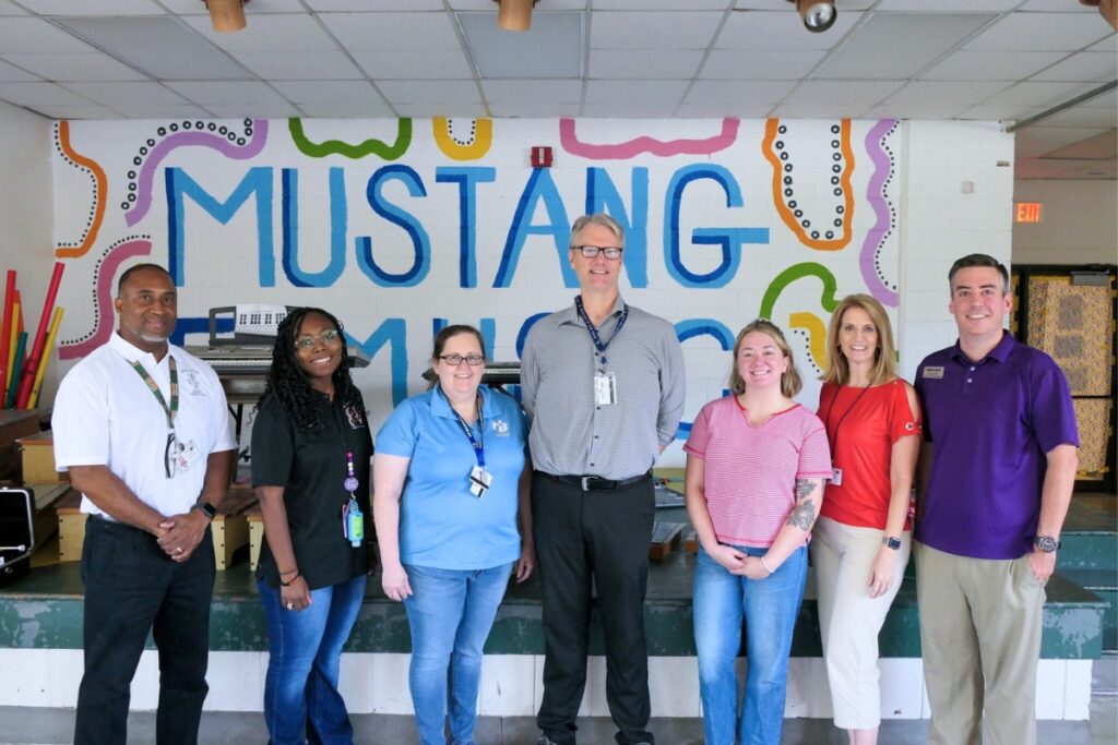 District music staff including Kristi Neal (second from left) and Stefie Pishock (third from right) host instrument fittings at Shell Elementary. Courtesy of ACPS