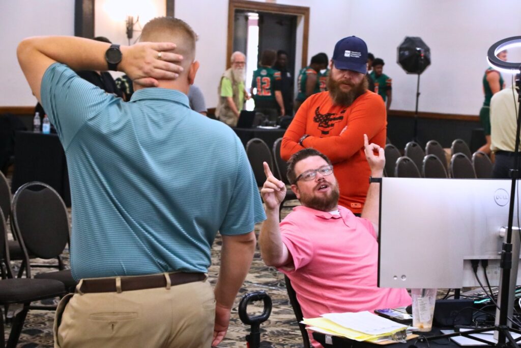 FloridaHSFootball.com's Joshua Wilson (center) directs the action at the North Central Florida High School Football Media Day on Thursday. Photo by C.J. Gish