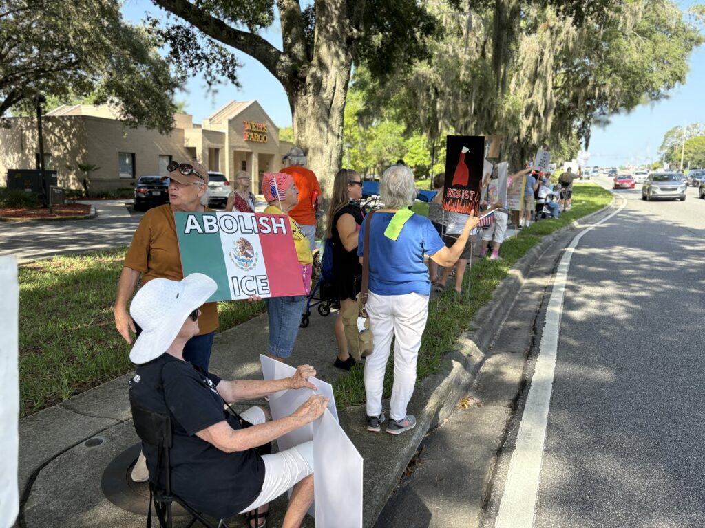 The crowd gathered Saturday along Newberry Road.
