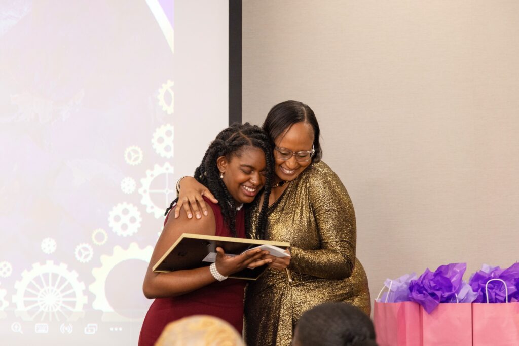 Shareen Baptiste hugs Jocari Livingston as she receives an award at an annual gala in December 2024. Courtesy Dream on Purpose