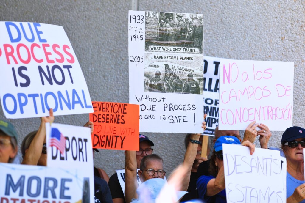 Signs at Friday's rally at the U.S. District Courthouse in Gainesville to oppose an ICE detention center at Camp Blanding in Starke. Photo by Seth Johnson