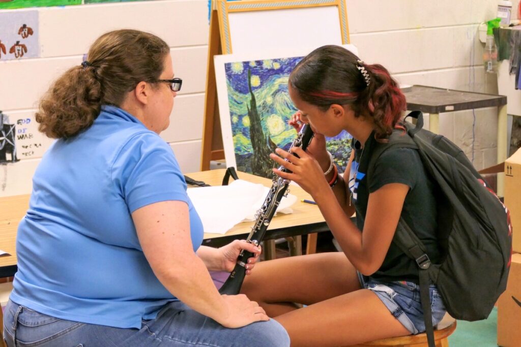 Students learn how to hold the clarinet during instrument fittings. Courtesy of ACPS
