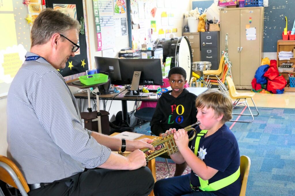 Todd Eckstein lets students test out the trumpet. Courtesy of ACPS