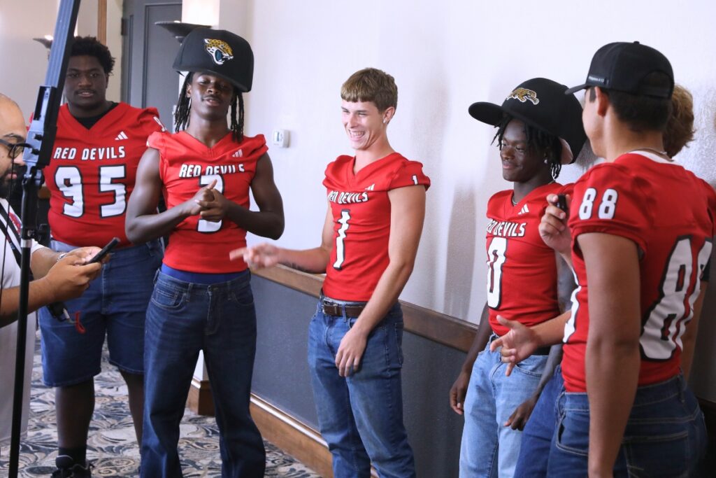 Williston players at the Jacksonville Jaguars booth at the North Central Florida High School Football Media Day on Thursday. Photo by C.J. Gish