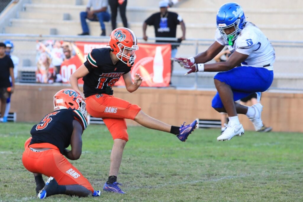 A Belleview defender misses blocking the extra point kick by Eastside's Elijah Dressell. Photo by Seth Johnson