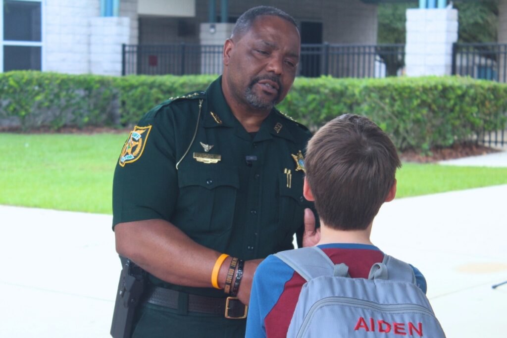 Alachua County Sheriff Chad Scott offers words of encouragement to a Kanapaha Middle School student on Monday morning. Photo by Nick Anshulz