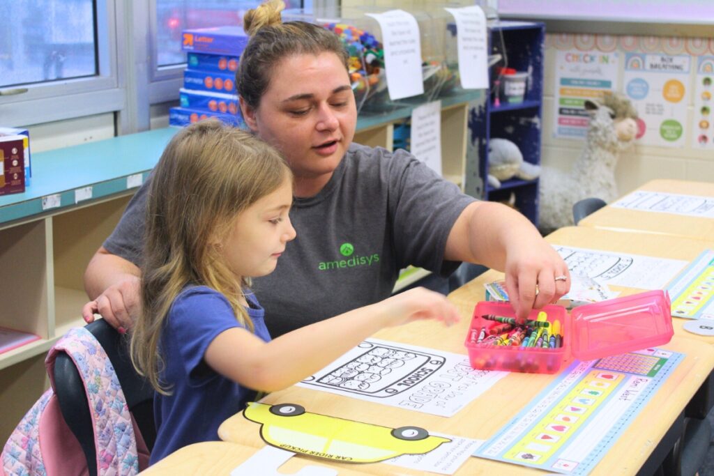 Alina West (right) helps her daughter, Remi West, choose a crayon for her coloring page on Monday morning. Photo by Nick Anshulz