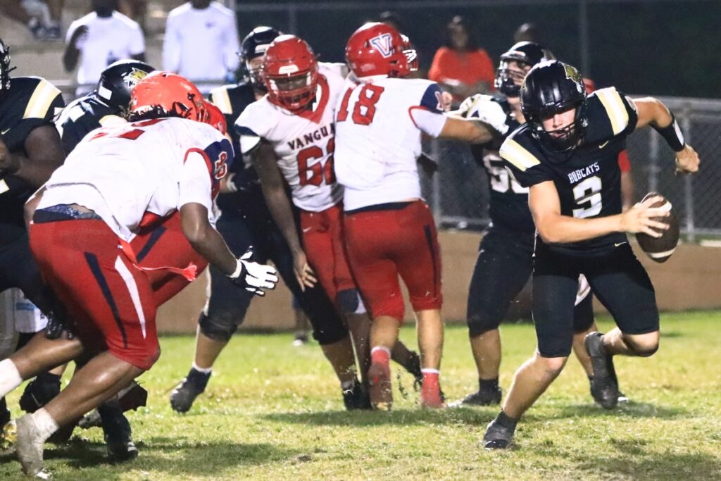 Buchholz quarterback Andrew Whittemore (9) scrambles from Vanguard (Ocala) pressure. Photo by C.J. Gish