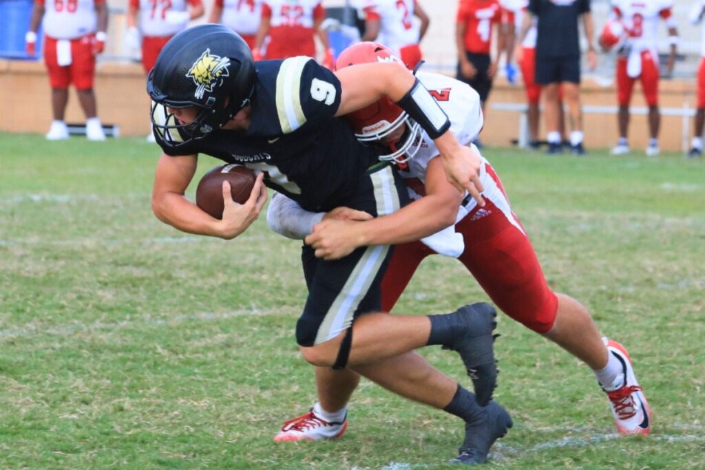 Buchholz quarterback Andrew Whittemore drives ahead on a run against Vero Beach. Photo by Seth Johnson