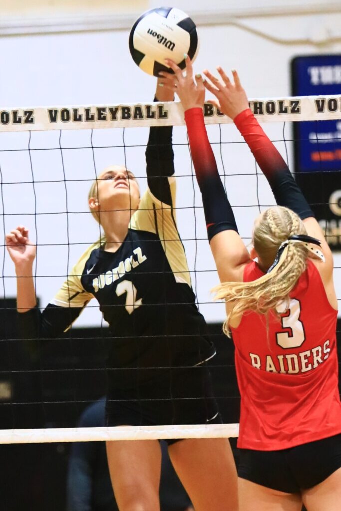 Buchholz's Addie Sixbey (2) with a hit against Santa Fe's June Poser-Wipke (3) in an August 2025 matchup. 