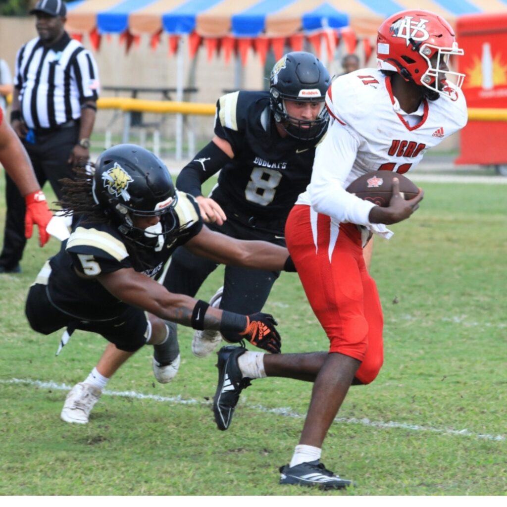 Buchholz's Caleb Young Jr. dives after a Vero Beach runner. Photo by Seth Johnson
