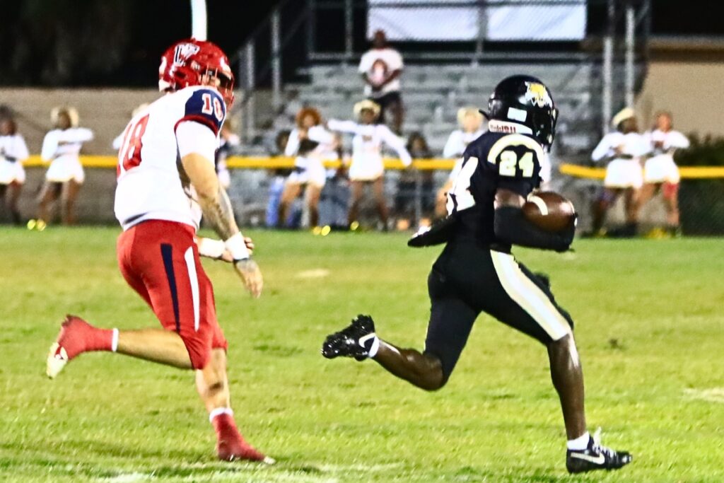 Buchholz's Camron Burse (24) returns a short punt for a first-quarter touchdown against Vanguard. Photo by C.J. Gish