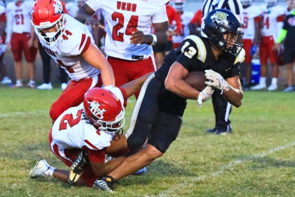 Buchholz's Justin Williams fights for extra yardage as a Vero Beach defender drags him down. Photo by Seth Johnson