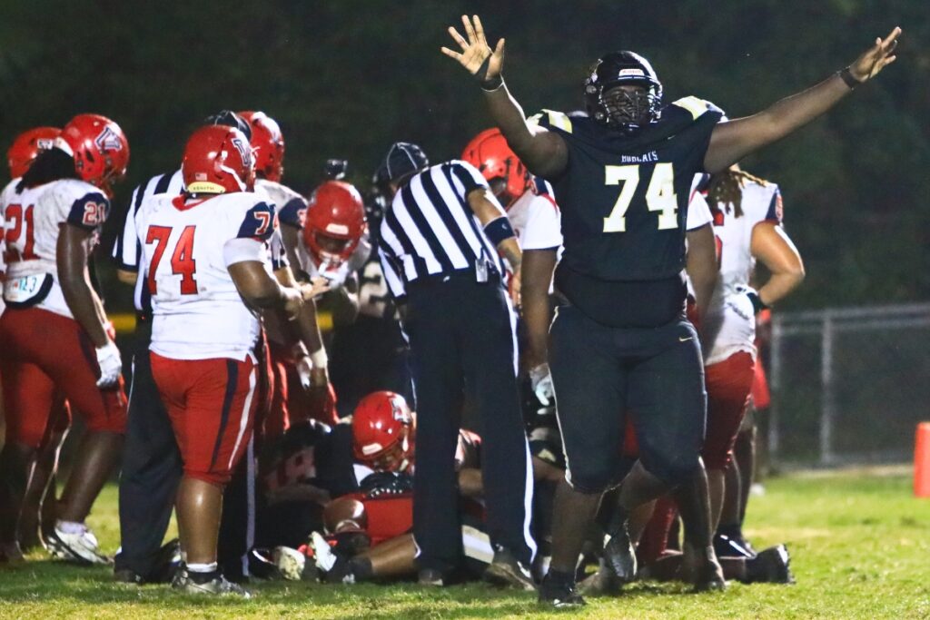 Buchholz's Michael Edwards (74) signals that Vanguard (Ocala) failed in its fourth-quarter two-point conversion run. Photo by C.J. Gish