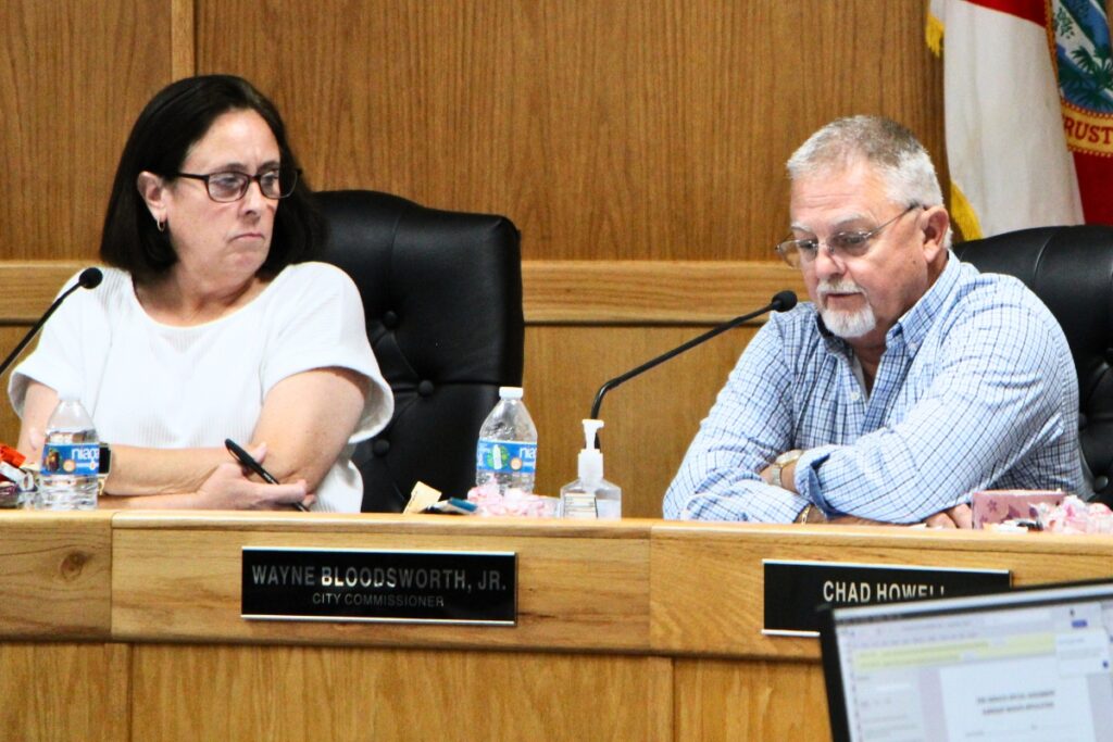 Commissioner Wayne Bloodsworth Jr. (right) discusses potential updates to the city's ordinance limiting alcohol sales within 500 feet of a church during a regular meeting. Photo by Lillian Hamman