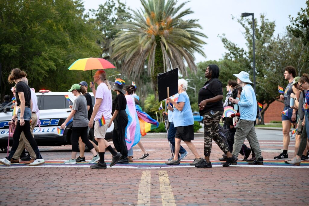 Community members rallied to protest the removal of the rainbow crosswalks in downtown Gainesville on Friday. Photo by Tim Rodriquez