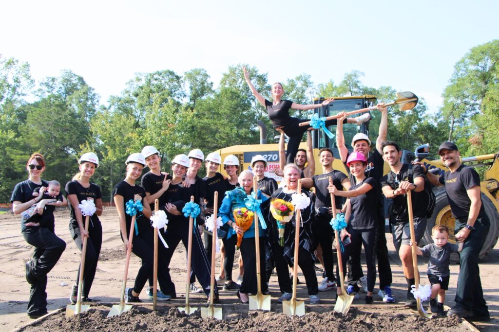 Dance Alive dancers strike dance positions on site of new studio with sister founders Judy Skinner and Kim Tuttle. Photo by Lillian Hamman