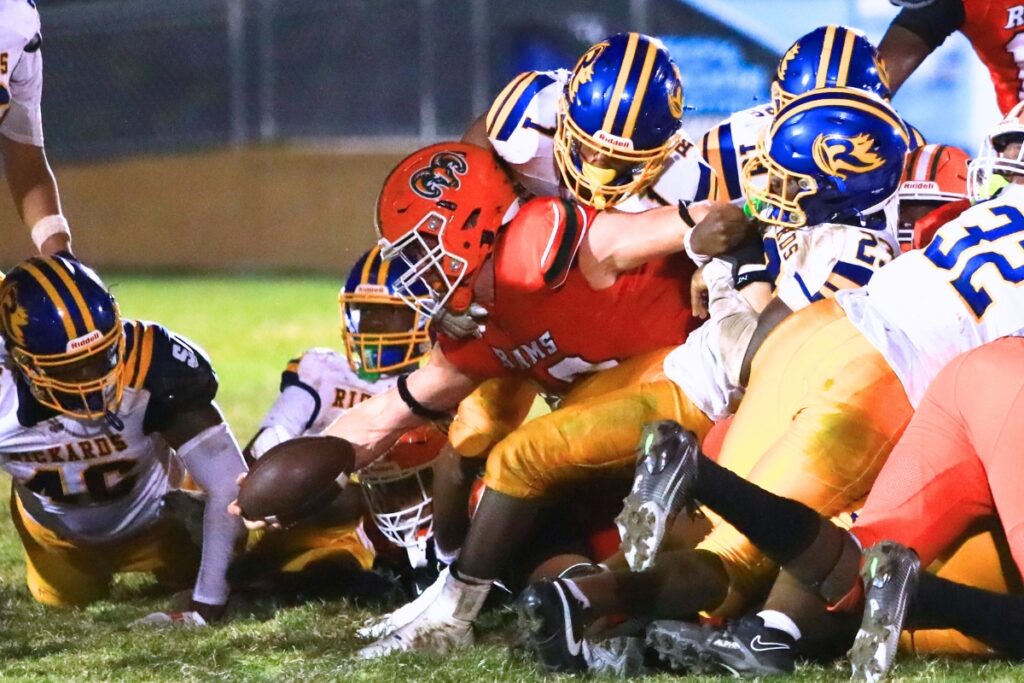 Eastside quarterback Nelson Tambling stretches for the game-ending first down in a 28-25 win against Rickards (Tallahassee). Photo by C.J. Gish