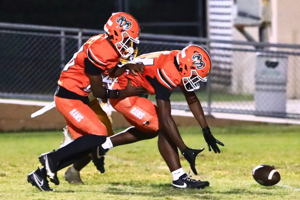 Eastside's Braeden Brockington (24) scoops up a fumbled kickoff return for a third-quarter touchdown against Rickards (Tallahassee). Photo by C.J. Gish
