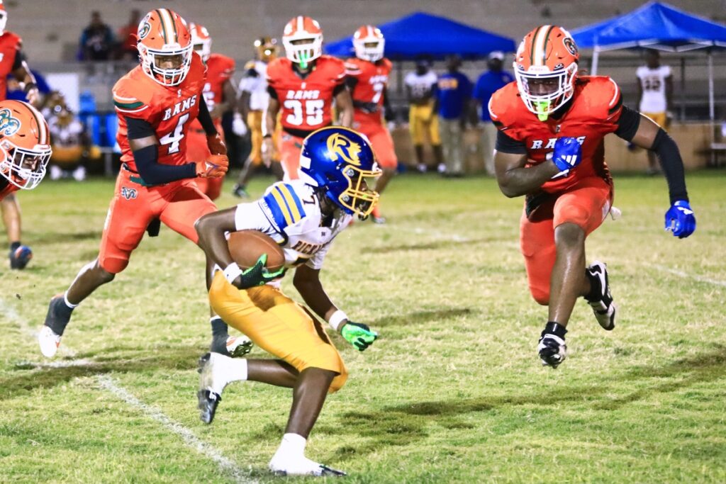 Eastside's Tramayne Montague (4) and Demarco Daniels (2) bottled up a running play against Rickards (Tallahassee). Photo by C.J. Gish